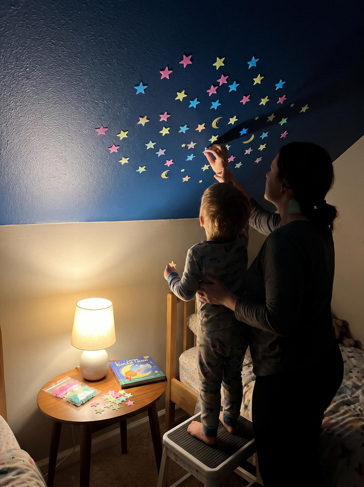 Placing glow star stickers on a bedroom wall