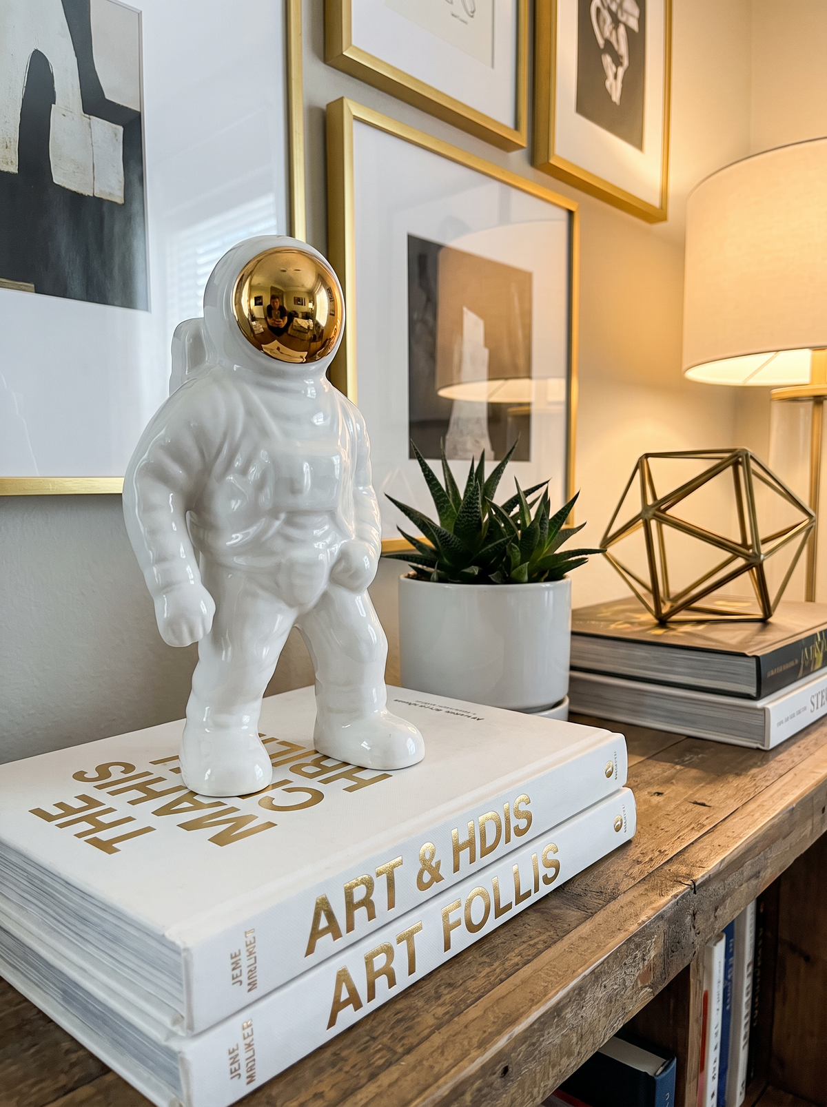 Gold and white ceramic astronaut statue in a modern room