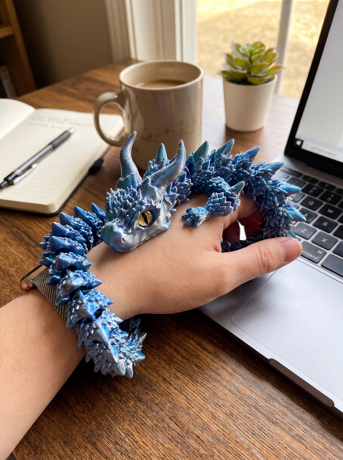 Dragon fidget toy posed on a desk
